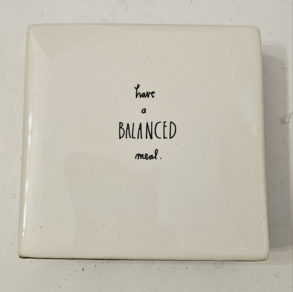 Rae Dunn Have a Balanced Meal Ceramic Stand with Dog Balancing a Bagel - Picture 2 of 5